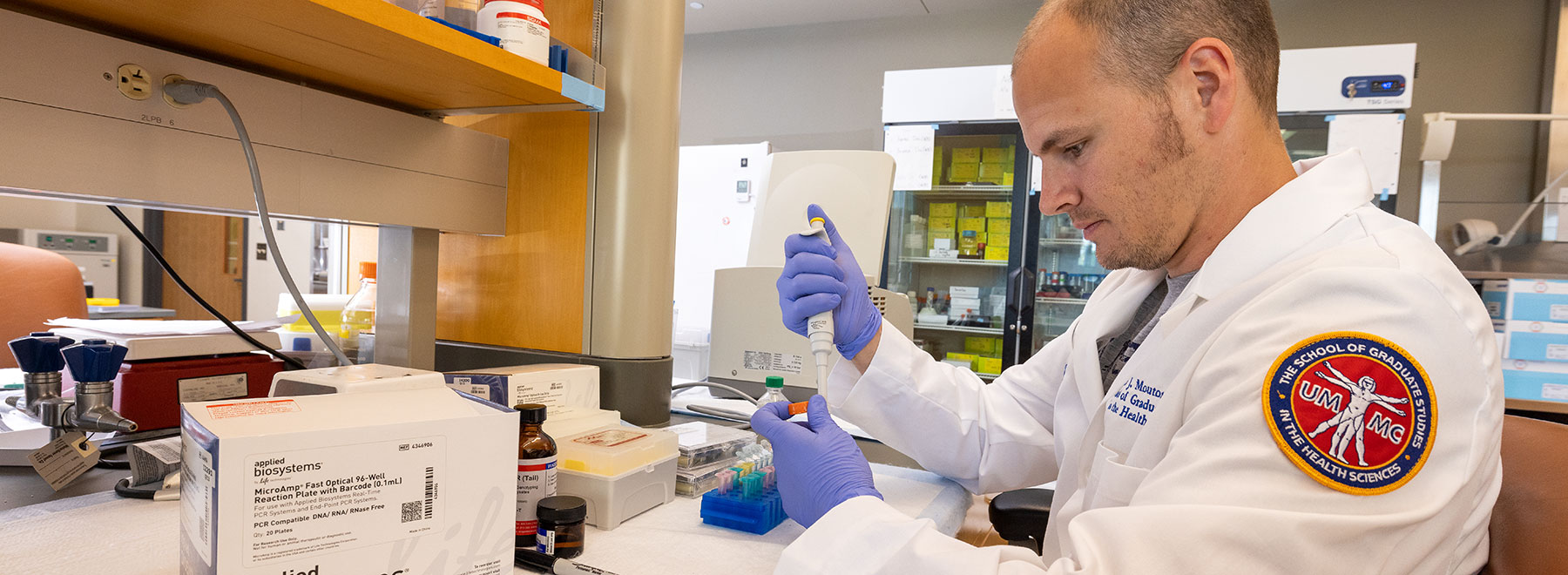 Researcher in lab filling test tubes